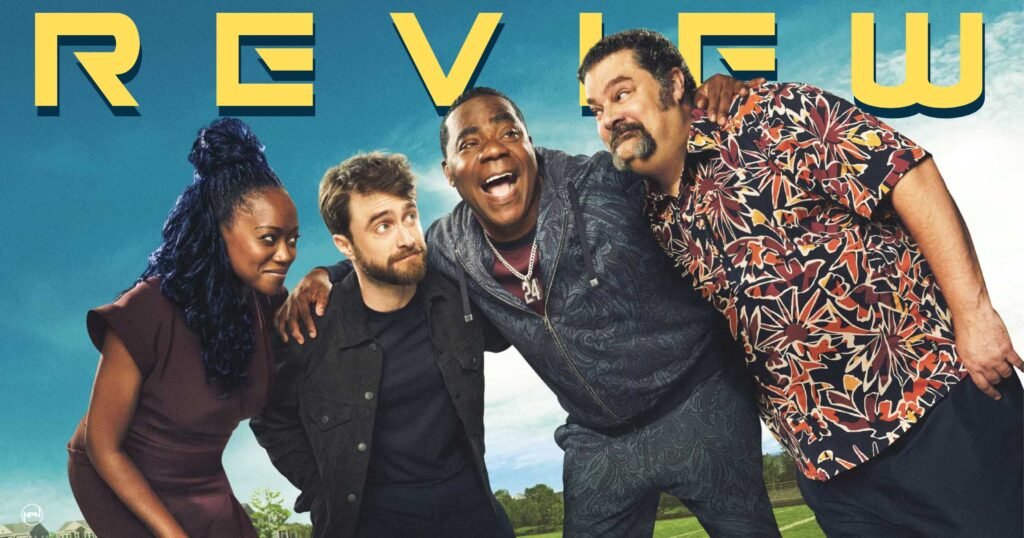 Erika Alexander, Daniel Radcliffe, Tracy Morgan, and Bobby Moynihan with their arms around each other and the word "Review" over their heads
